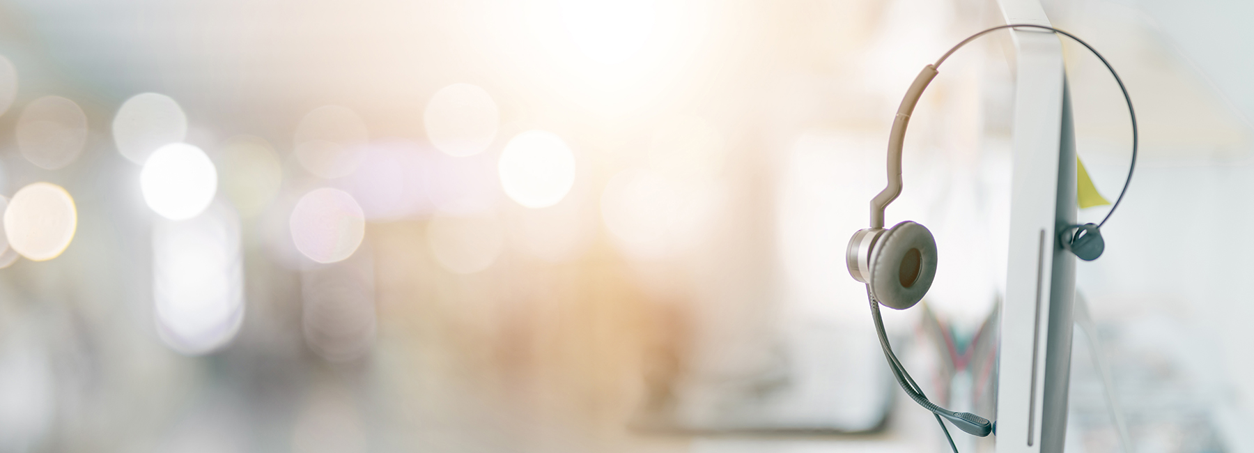 headphones perched atop computer monitor, Modern Workplace | DXC Technology
