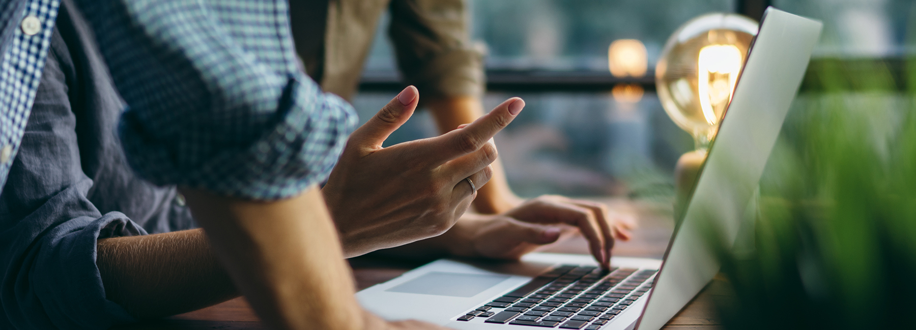 Three workers using a laptop to collaborate, Intelligent Collaboration | DXC Technology