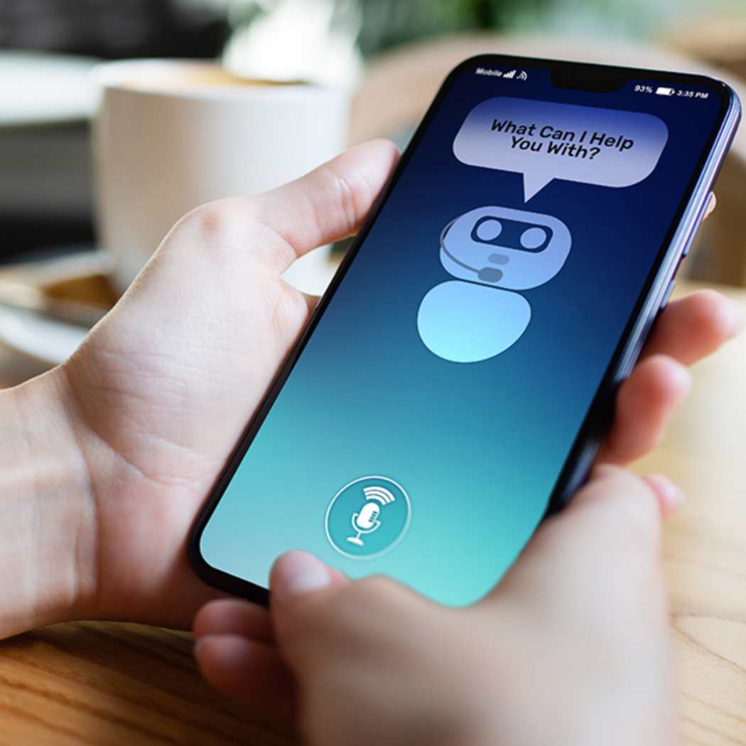 Two hands holding mobile phone, engaging with chatbot, Intelligent customer experience | DXC Technology