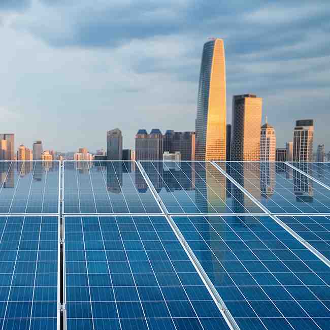 City skyline reflected in solar panels, Operational resilience | DXC Technology