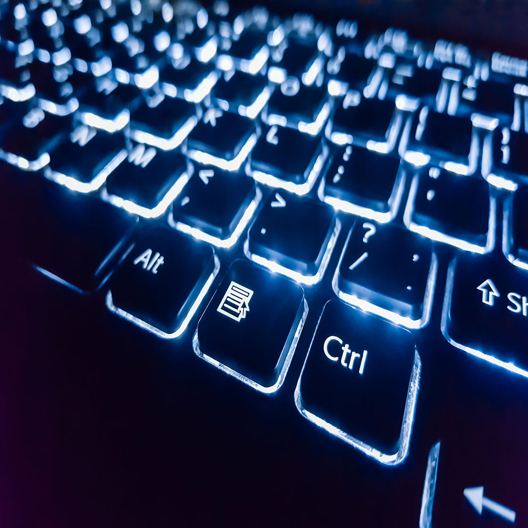 A lit-up keyboard, emphasizing infrastructure protection, application security, and data protection, Security | DXC Technology