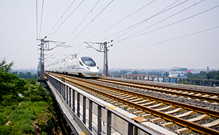 Bullet train racing quickly down rails with overhead power lines, cyber attacks, Security | DXC Technology Insights